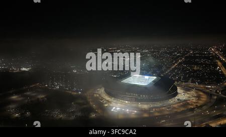 Aerial view of the illuminated Arena do Gremio stadium glowing amidst the surrounding city lights of Porto Alegre, Rio Grande do Sul, Brazil. Stock Photo