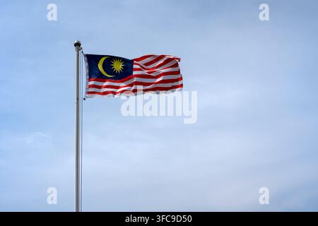 Malaysian flag on a pole with copy space Stock Photo