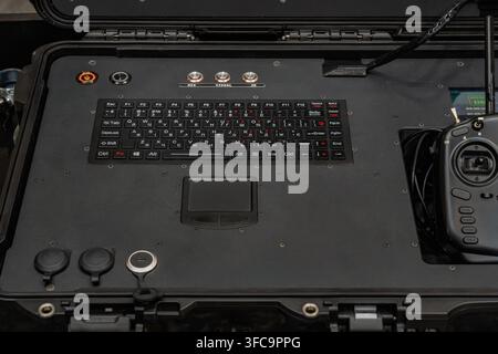 Tactical UAV control station interface panel featuring integrated keyboard, touchpad, push buttons, and radio remote controller Stock Photo