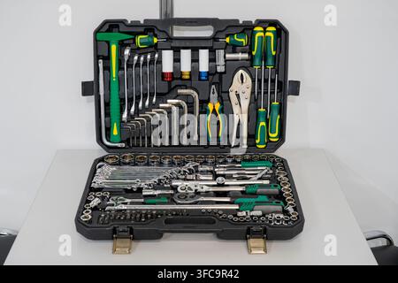 Complete mechanics tool set in open plastic case with ratchet handles, sockets, wrenches, screwdrivers, and pliers Stock Photo