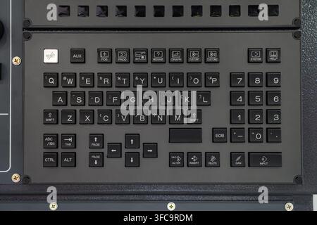 Close-up of industrial CNC machine control panel keyboard with QWERTY layout, function keys, and numeric keypad Stock Photo