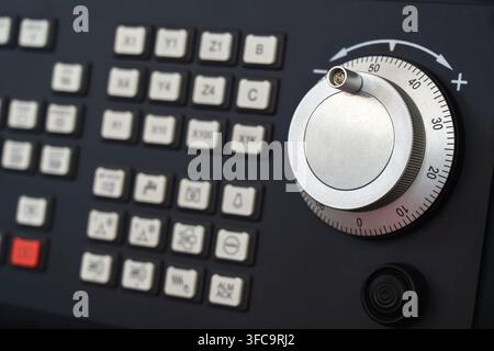 CNC machining control interface with large precision rotary dial and programmable function buttons, industrial automation and manufacturing equipment Stock Photo