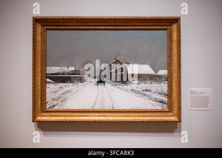 Minneapolis, MN - 23 Aug 25: Framed French winter landscape painting showing a snowy village road and carriage displayed at the Minneapolis Institute Stock Photo