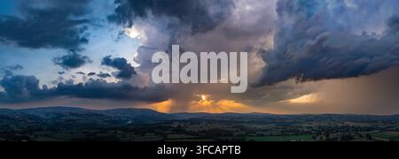UK Weather: Wednesday 26th August 2026, A Met Office Weather Warning now in place for North Wales as thunder and lightning along with heavy rain is to arrive over the next 48hrs.  A view of the Clwydian Range Hills as the Severe Weather approaches the village of Lixwm, Flintshire, UK Stock Photo