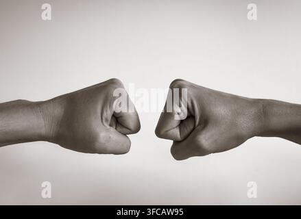 Man and woman giving fist bump. Black and white image. Stock Photo