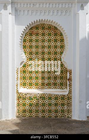 High resolution close up texture of traditional Moroccan zellij ceramic mosaic with arabesque geometric patterns in Asilah, Morocco. Stock Photo