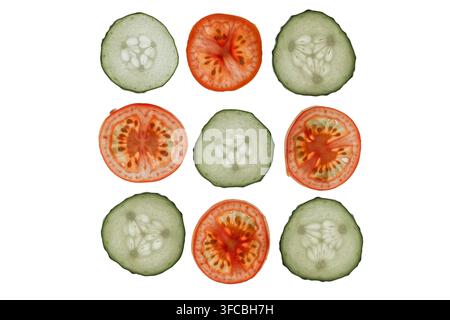 Sliced cucumbers and tomatoes arranged in symmetrical pattern, vibrant colors, minimalistic white background, clean commercial photography style, high Stock Photo