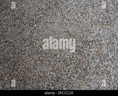 Close up of decorative tiny river rock embedded concrete pavement with smooth rounded multi color pebbles Stock Photo