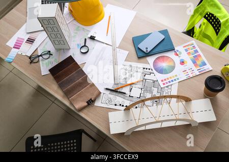Architecture and engineering design process overhead view of desk with blueprints models and tools for construction planning Stock Photo