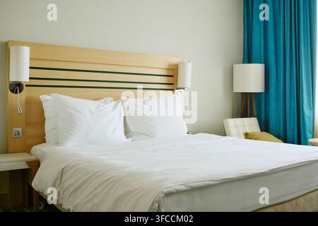 Cozy Hotel Room Bed with Pillows Ready for Guests Stock Photo