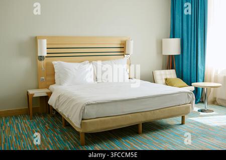 Empty Double Bed in Modern Hotel Room Ready for Guests Stock Photo