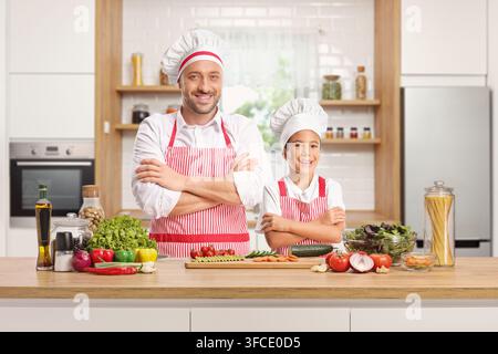 Father and son cooking together in a kitchen Stock Photo