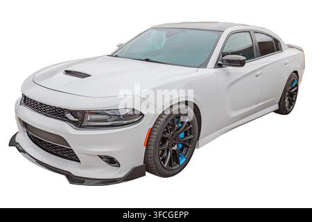 Isolated white sedan on transparent background, sleek modern design, sporty front grille, angular headlights, subtle air intake, black multi-spoke whe Stock Photo