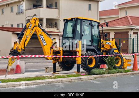 Road construction and infrastructure development JCB backhoe loader with jackhammer at the Spanish Gibraltar border in Gibraltar. Stock Photo