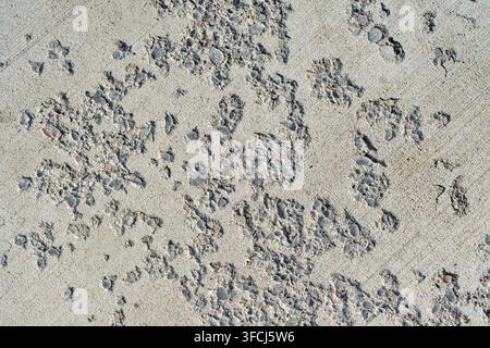 Weathered concrete surface with exposed stone aggregate. Stock Photo