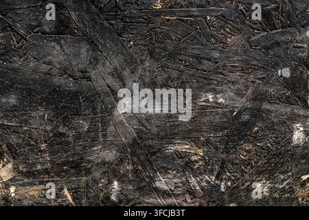 Black painted oriented strand board OSB wood texture. Stock Photo