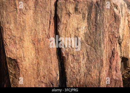 Quartzite rock is a non-foliated metamorphic rock red in color due to presence of iron oxide. It forms from sandstone in tectonic compression in oroge Stock Photo
