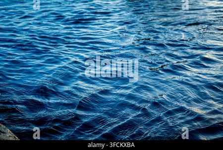 Gentle ocean waves creating intricate patterns across the deep blue water Stock Photo