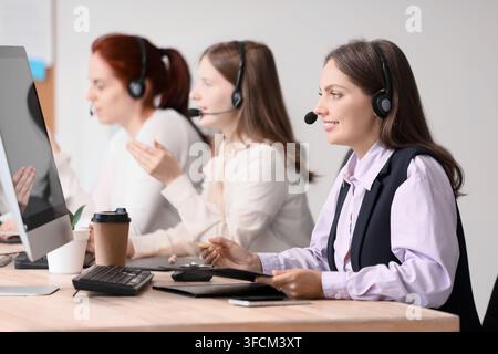 Customer support and call center service, diverse team of operators working on computers with headsets in a modern office environment Stock Photo