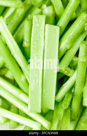 Close-up of chopped celery stalks filling the frame on a white background. Stock Photo