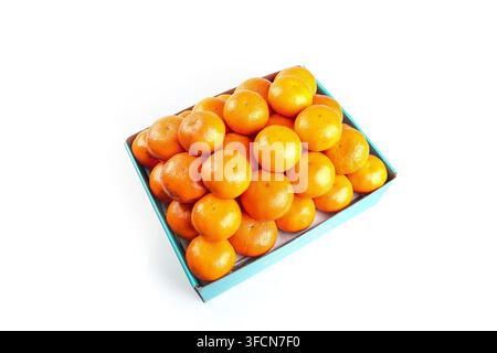 Pile of mandarins in a blue tray isolated on a white background. Stock Photo