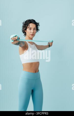 Woman practicing with a stretching band, doing arm exercises Woman practicing with a stretching band, doing arm exercises Russia Copyright: xxArtemxVa Stock Photo