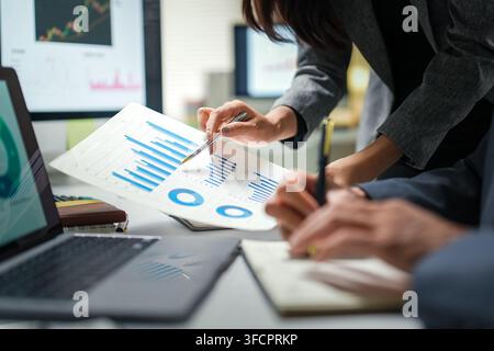 Business Team Analyzing Financial Charts in Office Stock Photo