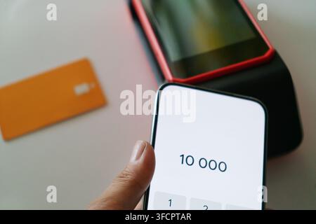 Cashless payment using smartphone on modern bank terminal Stock Photo