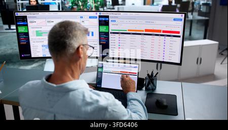 Healthcare Analyst Carefully Reviews Denial Management Dashboard On Laptop Computer. Stock Photo