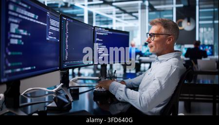 Software Developer Carefully Debugging Code Using Cloud-based Programming Tools. Stock Photo