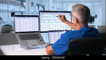 Doctor Uses Touchscreen Computer To Review Patient Health Data Efficiently. Stock Photo