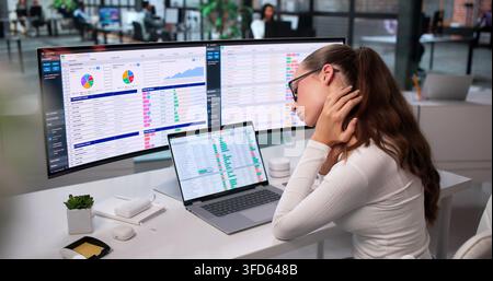 Tired Businesswoman Works Late On Complex Reports Feeling Headache Pain. Stock Photo