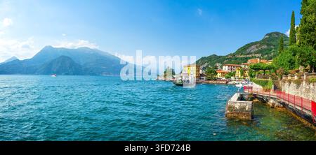 Panoramic view of Varenna waterfront on Lake Como with colourful village houses, promenade, and surrounding mountains. Lecco, Lombardy, Italy Stock Photo