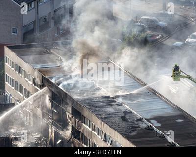 Firefighters tackle a major flat fire at Belgrave Walk in Mitcham, south London, with extensive damage to homes, 25 July 2026. Stock Photo