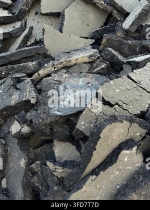 Cracked dry earth texture with scattered pieces, suitable for natural background or environmental theme. Mobile photo Stock Photo