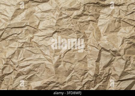 Crumpled brown paper texture background with wrinkles Stock Photo