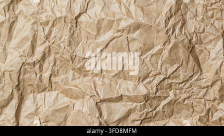 Crumpled brown paper showing a textured surface with creases and wrinkles Stock Photo