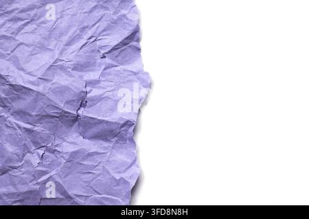 Crumpled purple paper showing texture and torn edge on a white background Stock Photo