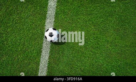 Textured soccer game field with soccer ball - center, midfield view from above. Stock Photo