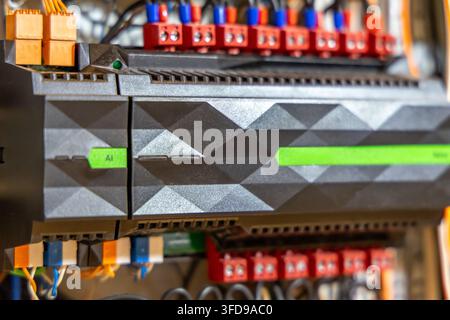 Detailed view of a modern industrial automation controller unit, showcasing its intricate design and electrical connections for system integration Stock Photo