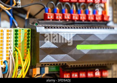 Detailed view of electrical connections and modules within an industrial control panel, highlighting intricate wiring and electronic hardware Stock Photo