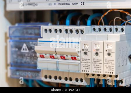 Detailed shot of a residential electrical panel featuring multiple circuit breakers and wiring, showcasing modern home electrical systems Stock Photo