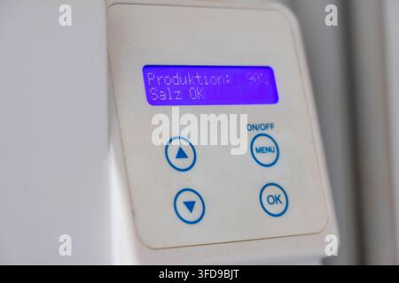 The digital display shows 'Produktion: 90%' and 'Salz OK' indicating a successful production cycle with sufficient salt levels Stock Photo