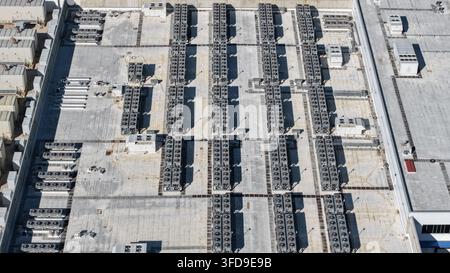 Large data center building rooftop showing rows of air conditioning and ventilation units Stock Photo