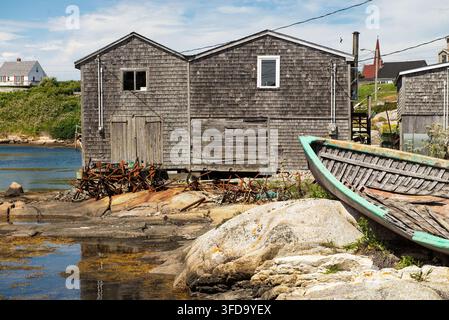 Old Fishing Boats Resting on a Sandy Beach Along a Peaceful Tropical Coastline Under a Beautiful Sky, Authentic Coastal Maritime Scene with rusty anch Stock Photo