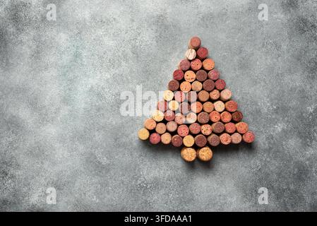 Wine corks in the shape of a Christmas tree on a gray concrete background. View from above. Creative layout. Stock Photo
