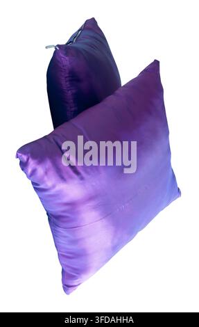 Two purple pillows after use in stack are isolated on white background with clipping path. Stock Photo