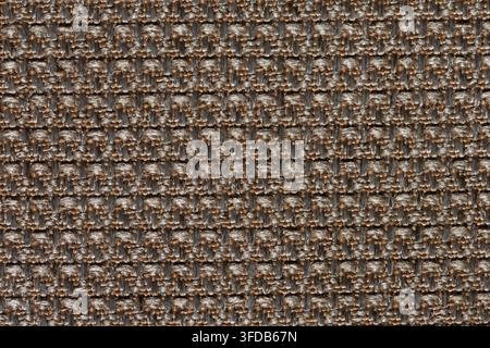 Macro close up of coarse woven upholstery fabric showing brown and beige threads in a dense checkered weave, used as a textile texture background Stock Photo