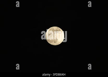 bright full moon floating on sky in night background Stock Photo