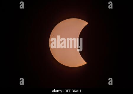Partial phase of total solar eclipse August 12 2026 showing sunspots and moon silhouette - astrophotography. Stock Photo